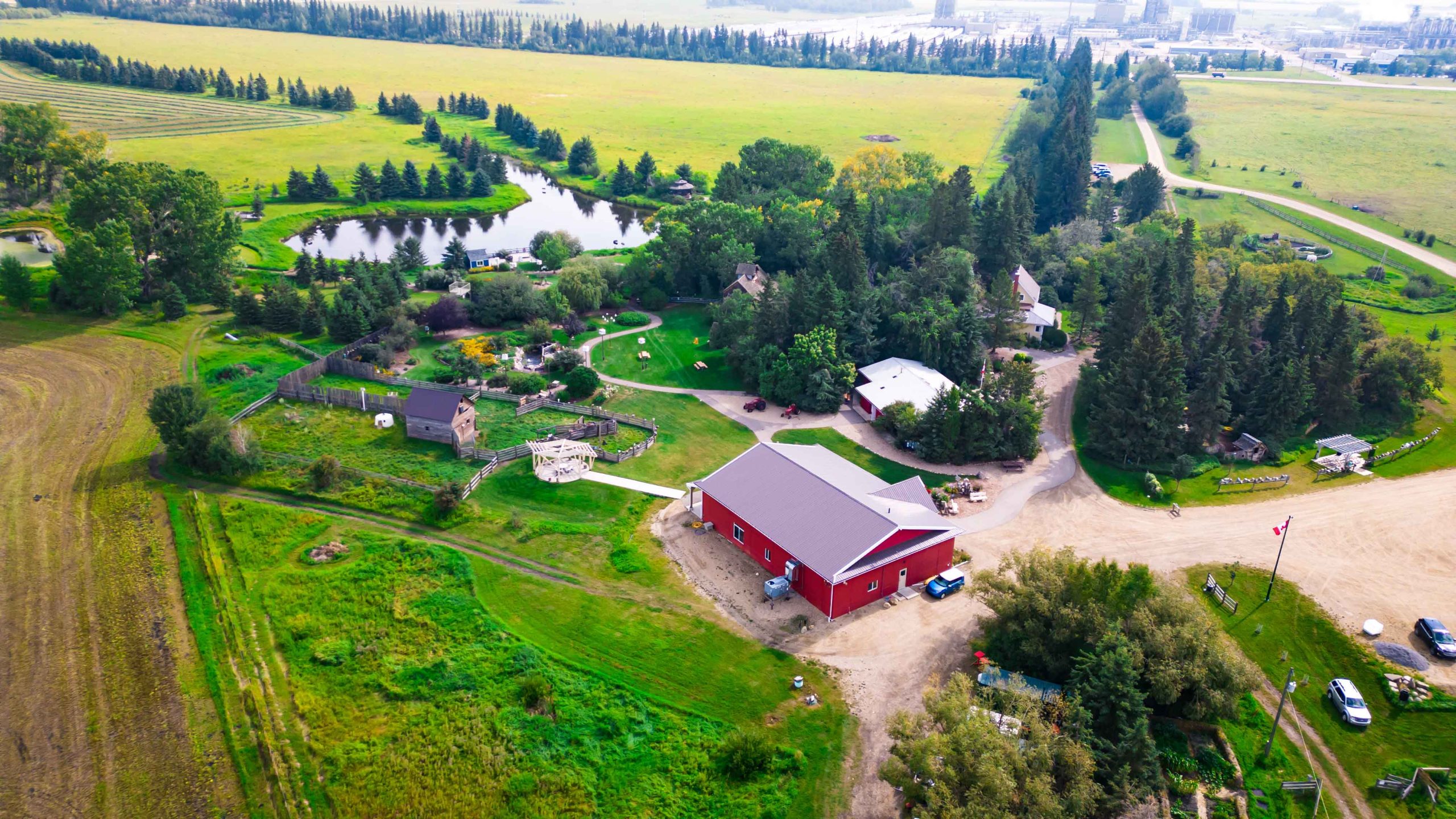 Ellis Nature Centre aerial photo with red barn and green fields and trees along pond