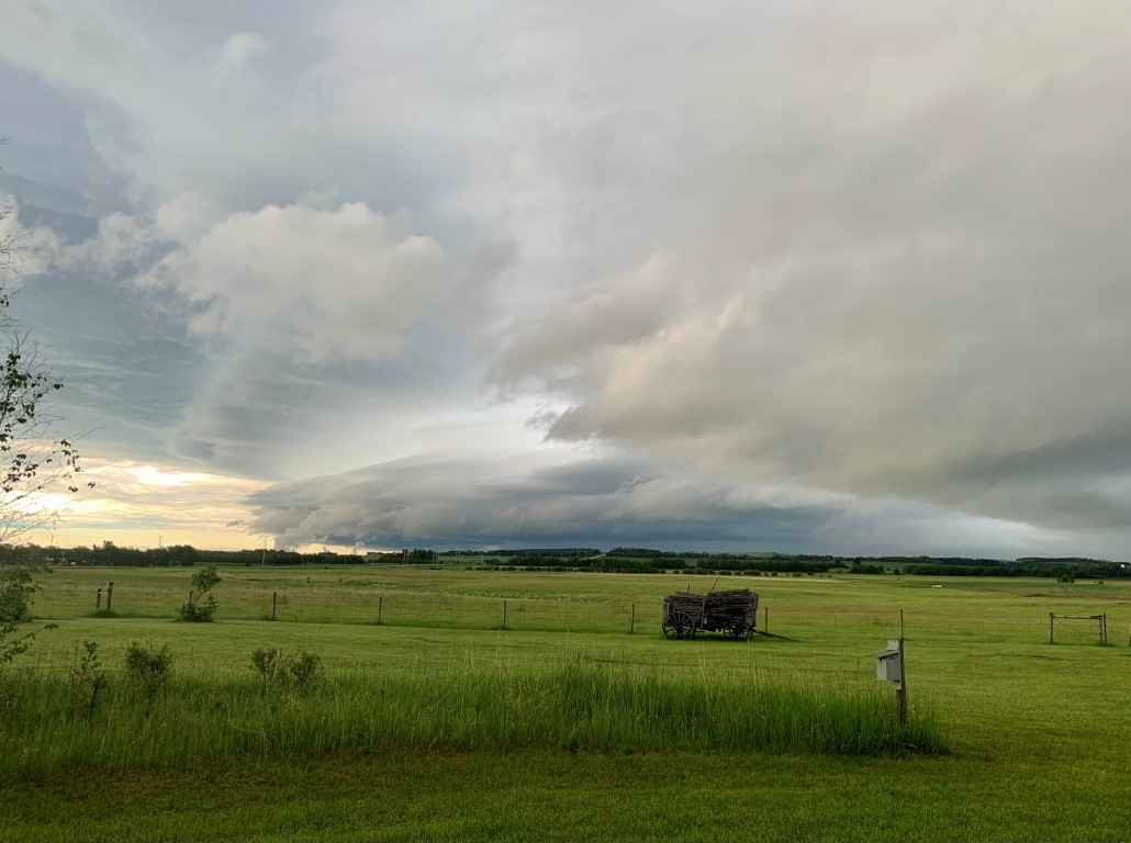 wagon field with storm clouds